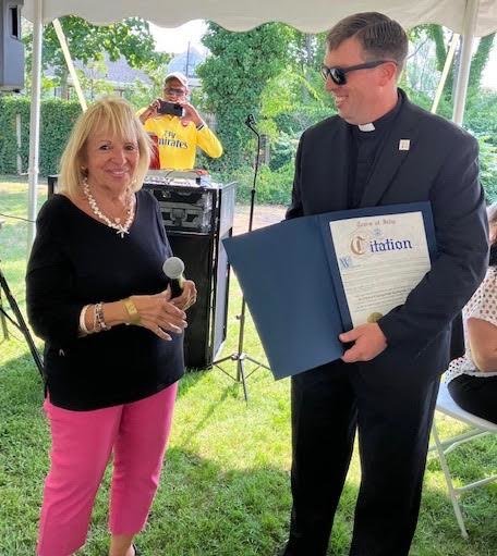 Islip Town supervisor presents pastor Brian Noack with a citation in honor of St. John’s Lutheran Church’s 125th anniversary. 
